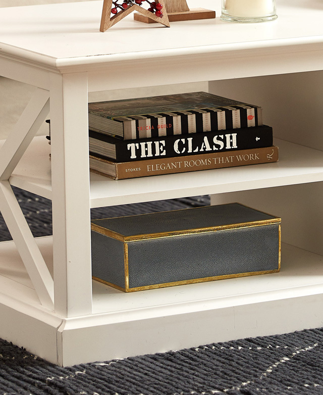 The focal points are the two end shelves that hold a stack of coffee table books, and a metallic-trimmed box. The focal points are the two end shelves that hold a stack of coffee table books, and a metallic-trimmed box.