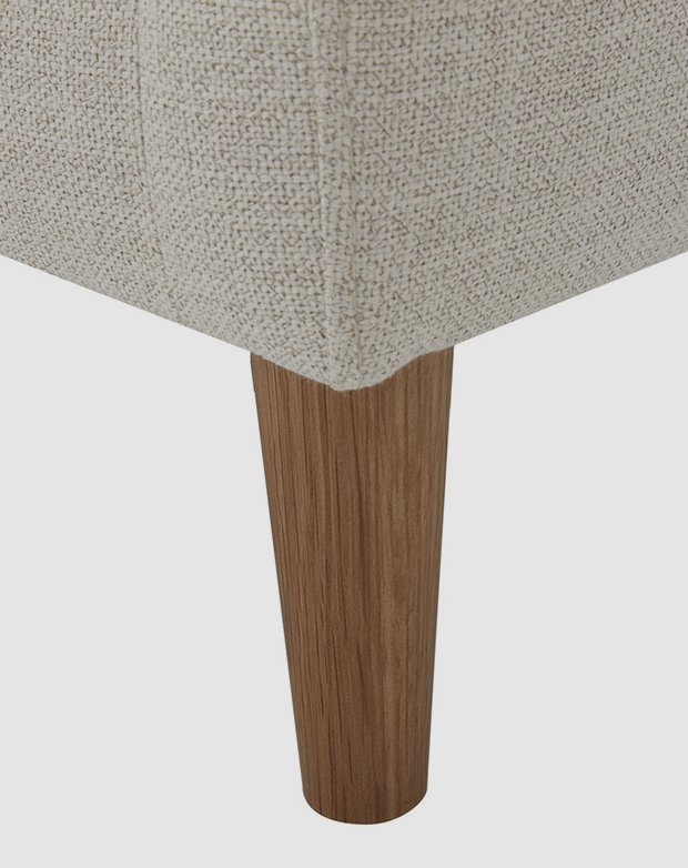 Large-scale view of a sofa leg shows its straight red oak wood grain. It has been tapered for aesthetics and stability. Large-scale view of a sofa leg shows its straight red oak wood grain. It has been tapered for aesthetics and stability.