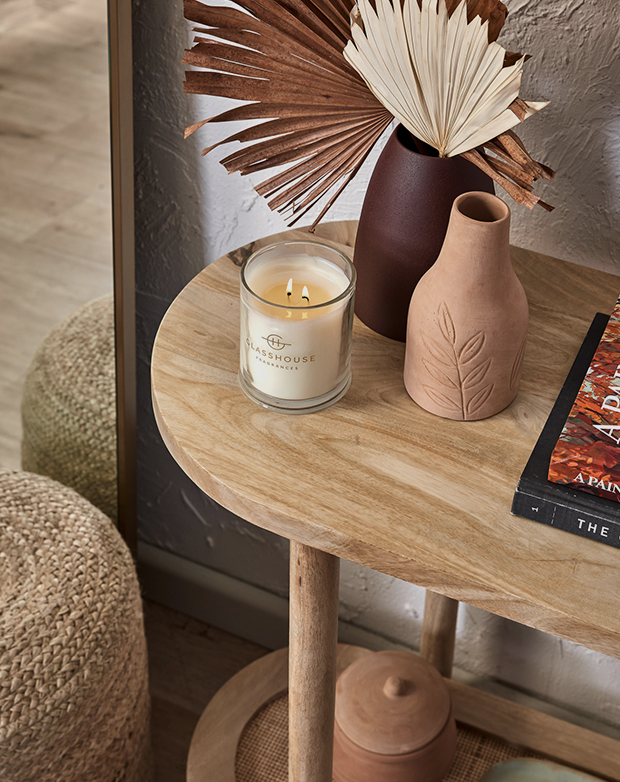Bird's-eye view of a rattan and timber console table with candles and decorative vases styled on the top surface. Bird's-eye view of a rattan and timber console table with candles and decorative vases styled on the top surface.