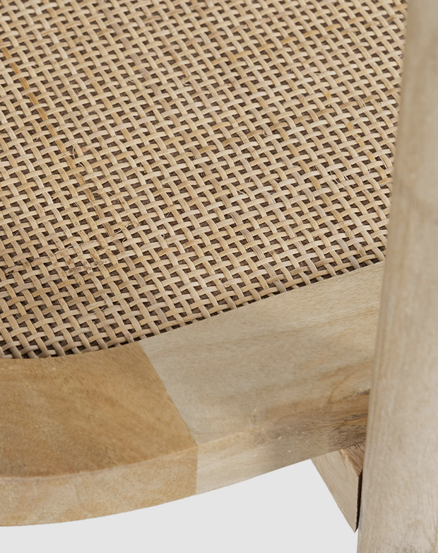 The bottom shelf of a timber console table is made of rattan, and features a stylish crosshatch weave.