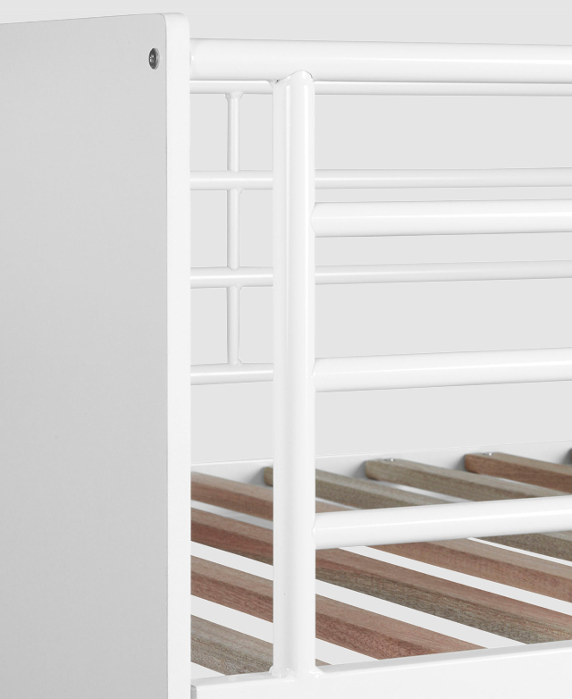 The white painted rail for the top bunk is shown, with the slatted base discernible between the metal poles. The white painted rail for the top bunk is shown, with the slatted base discernible between the metal poles.