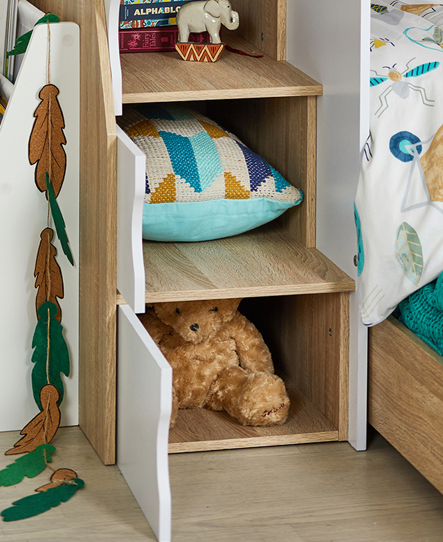 The box steps double up as storage cupboards, with three cupboard doors open and showing a teddy bear, a cushion, and games. The box steps double up as storage cupboards, with three cupboard doors open and showing a teddy bear, a cushion, and games.