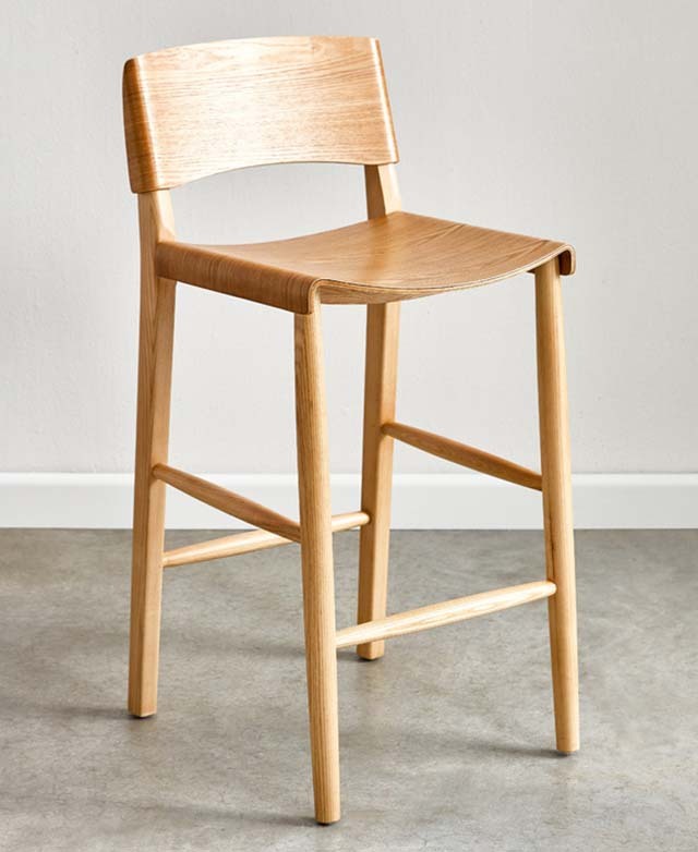Full view of a modern bar stool, made of solid ash and featuring a bentwood seat and backrest.