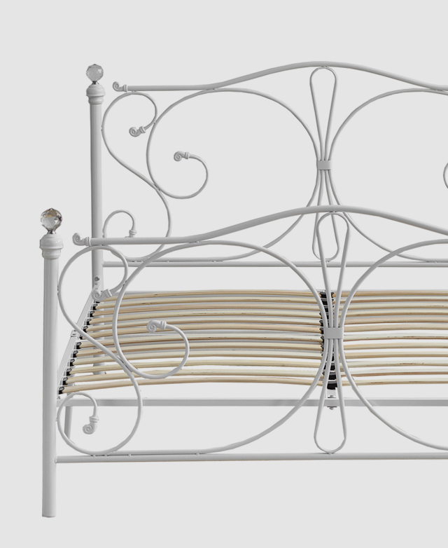 Front-on view of the bed demonstrates the decorative yet timeless appeal of the curved metal frame. Front-on view of the bed demonstrates the decorative yet timeless appeal of the curved metal frame.