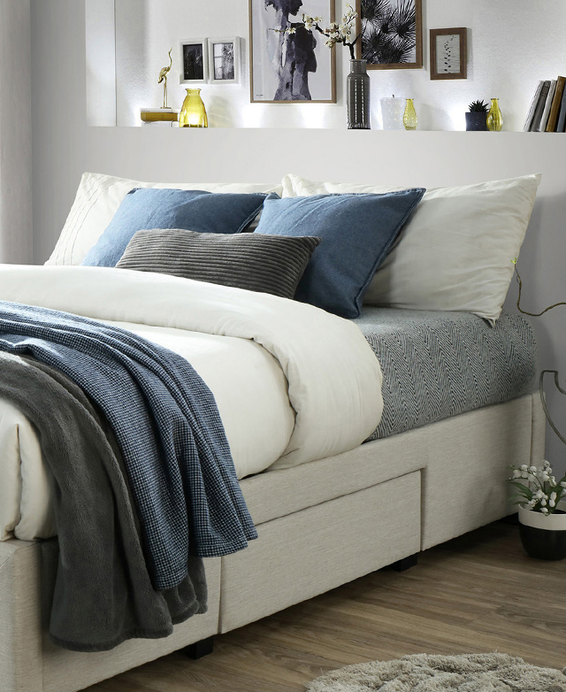 The bed is fully assembled and dressed. The understated, upholstered frame is just in the frame.