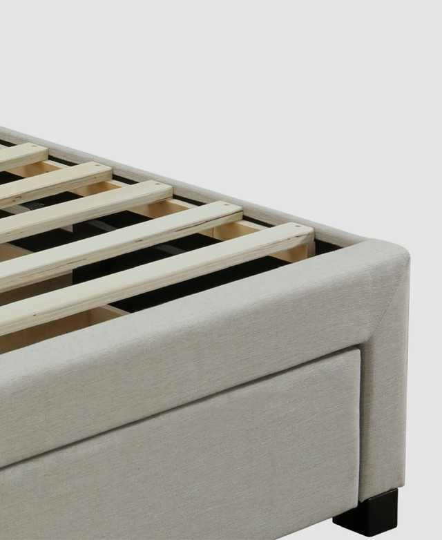A close up of an end corner highlights the simplicity of the slatting and the neutral upholstery.