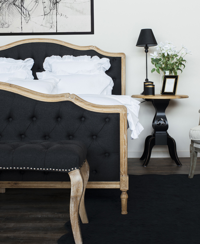 The classic bed frame is dressed in white sheets and styled in an elegant bedroom interior featuring French-provincial decor. The classic bed frame is dressed in white sheets and styled in an elegant bedroom interior featuring French-provincial decor.