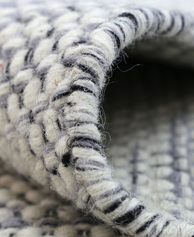 Detailed close-up zones in on the soft yet wiry texture of wool, as well as the cool, varied tones of the fibres.