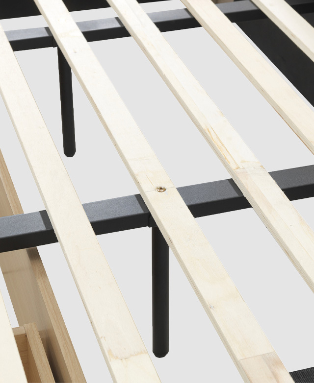 Laminated veneer engineered wood slats are close up and crossing over a central metal support bar.