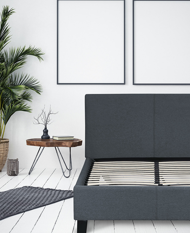 The bed frame is shown without a mattress in a bright white room, on white-painted floorboards. The bed frame is shown without a mattress in a bright white room, on white-painted floorboards.
