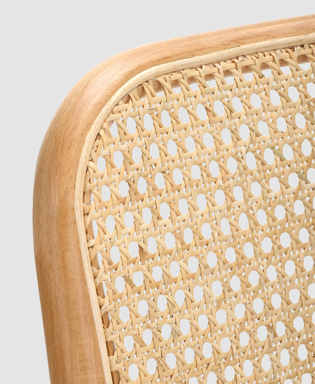 The rattan weave is magnified, and the bentwood frame around the backrest is shown to have a smooth finish. The rattan weave is magnified, and the bentwood frame around the backrest is shown to have a smooth finish.