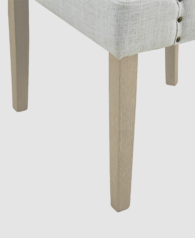 Close-up of solid rubberwood legs underneath a chair. The rectangular shape is gently tapered. Close-up of solid rubberwood legs underneath a chair. The rectangular shape is gently tapered.