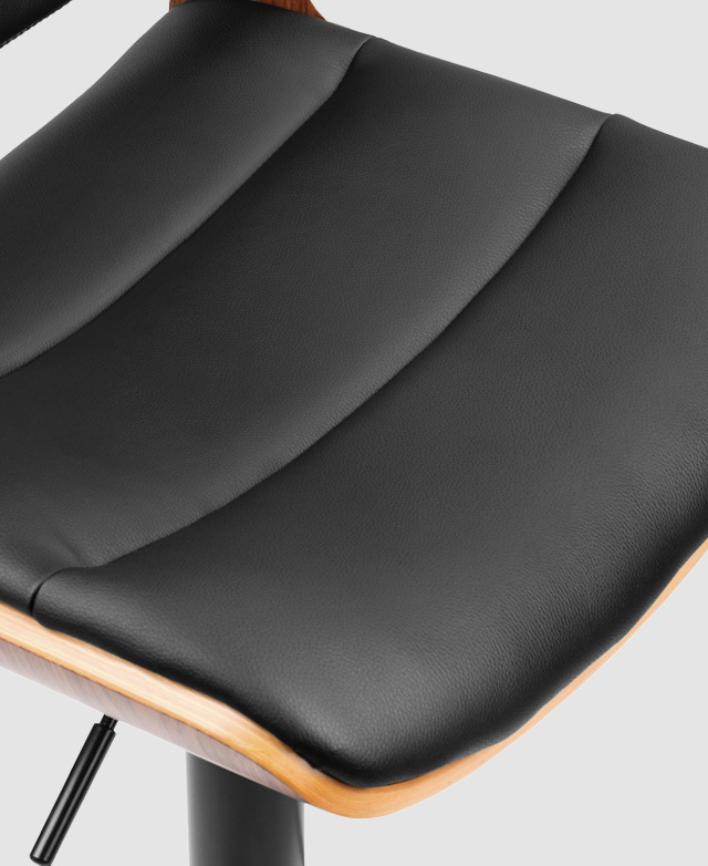 A top-down angle highlights the seat's smooth PU leather and the panelled components. A top-down angle highlights the seat's smooth PU leather and the panelled components.