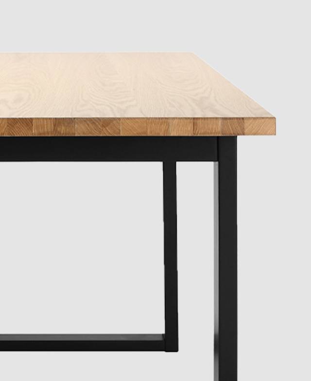 Cropped half-view of the table, including the veneer top and black legs.
