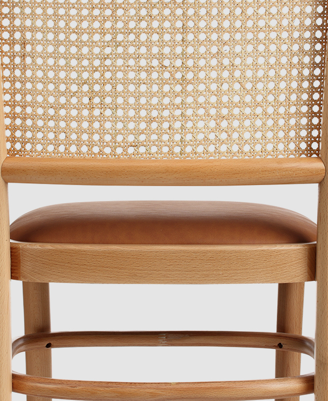 The rattan backrest has an open-weave style, creating a semi-transparent appearance.