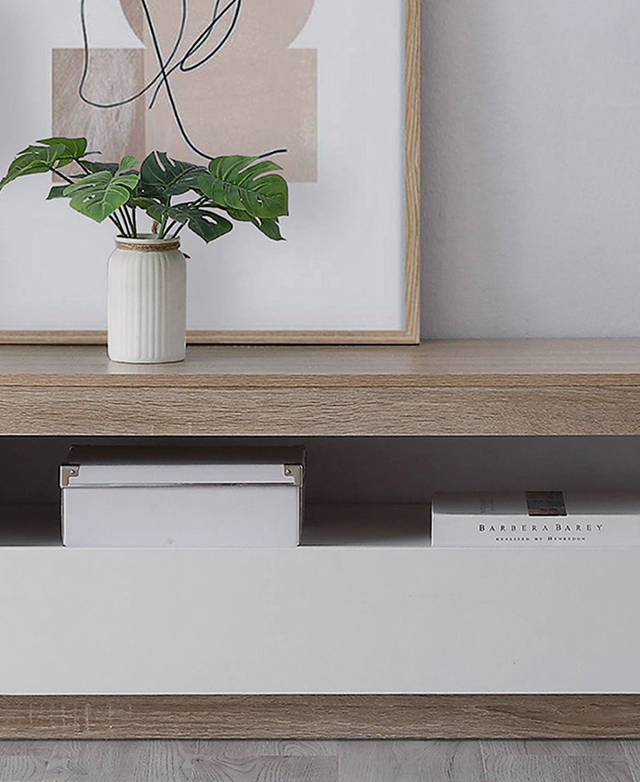 The timber-look base and top is contrasted with a crisp white middle section. A plant sits on top. The timber-look base and top is contrasted with a crisp white middle section. A plant sits on top.