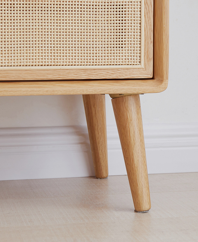 Corner view of the base of the side table highlights its elegantly tapered and splayed oak wood legs. Corner view of the base of the side table highlights its elegantly tapered and splayed oak wood legs.
