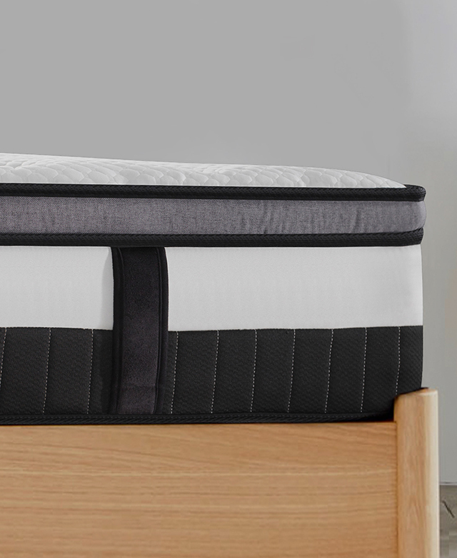 Side angle shows the depth of the mattress, its bold piping trims, and the fabric handle.