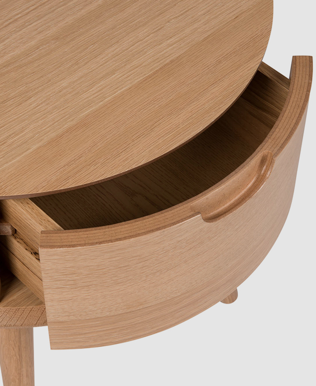 The drawer is slightly pulled out, accentuating its convex shape from above.