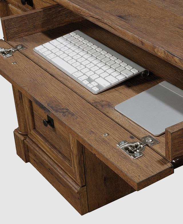 A functional flip-down panel reveals space to store a keyboard and mouse. A functional flip-down panel reveals space to store a keyboard and mouse.