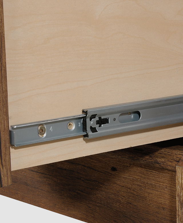 The metal extension runner on the side of the drawer is in focus. The metal extension runner on the side of the drawer is in focus.