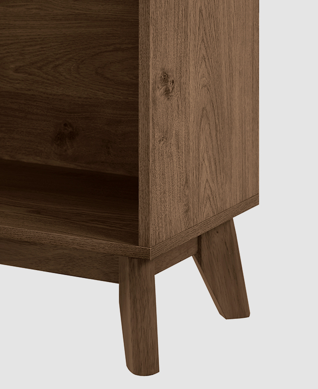 Angled corner view of the bookcase base shows the dark timber grain of the laminate particle board.