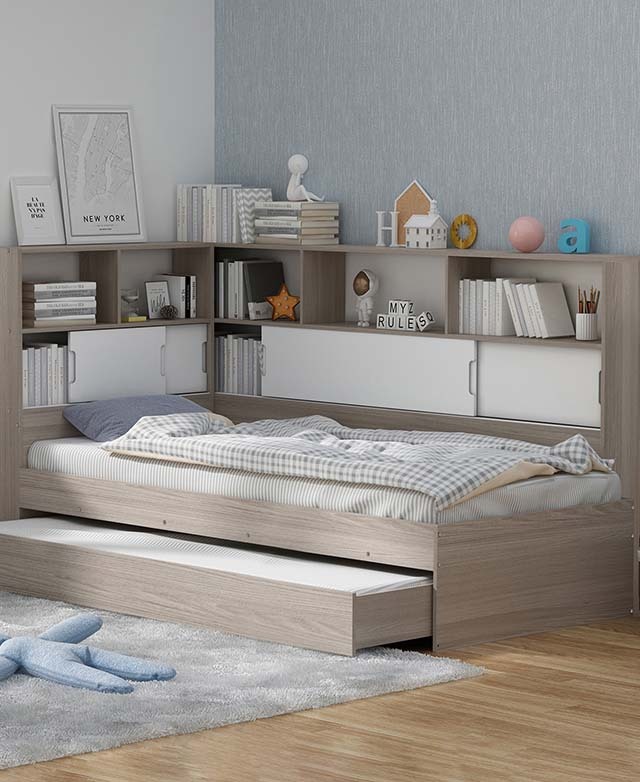 The bookcase, wall tower, and trundle are attached to the bed frame for a complete and functional set-up.