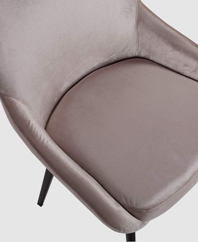 A top-down view captures the rounded seat and the low armrests that frame it.