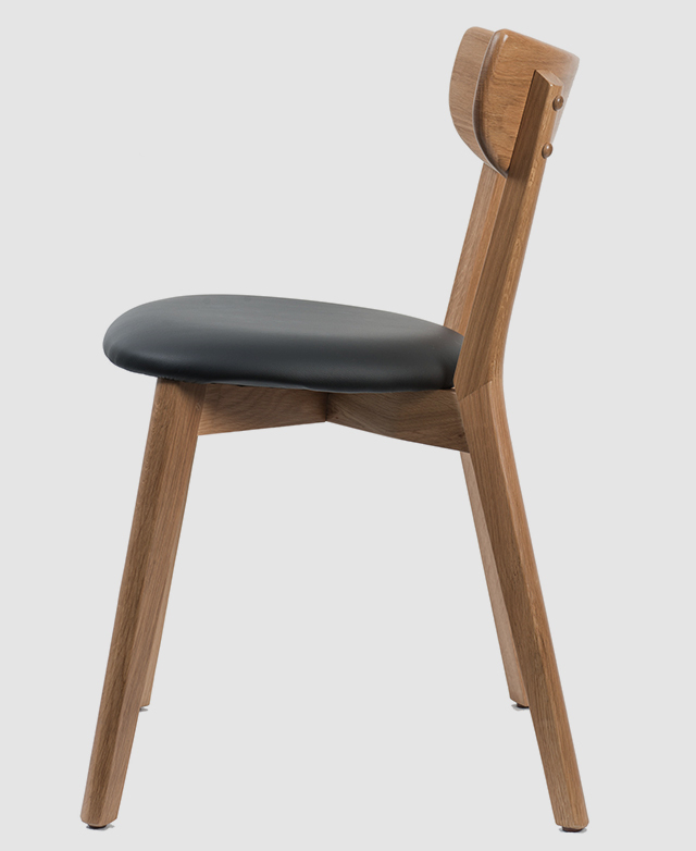 Side profile of the chair highlights the supportive curvature in the backrest and stable splaying of the legs.