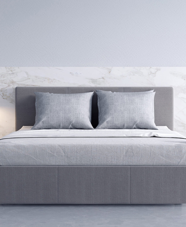 Varying grey tones form a soothing space, with the bed centre stage. The bed is placed in front of a marble patterned wall. Varying grey tones form a soothing space, with the bed centre stage. The bed is placed in front of a marble patterned wall.