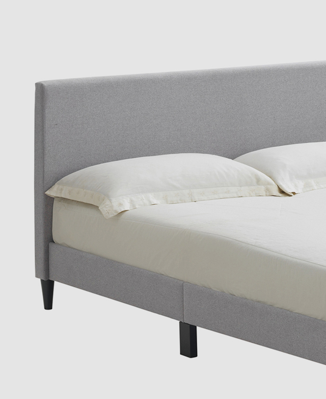 A top quarter of the bed is shown with a mattress on top, with a cream fitted sheet, and standard pillows by the bedhead. A top quarter of the bed is shown with a mattress on top, with a cream fitted sheet, and standard pillows by the bedhead.