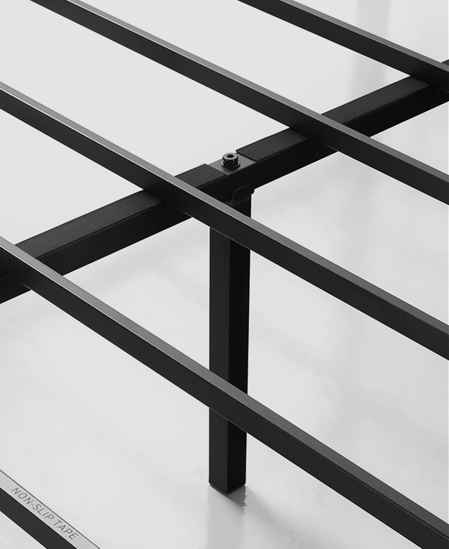 Evenly spaced apart, black metal slats that sit underneath the mattress are shown up close. Evenly spaced apart, black metal slats that sit underneath the mattress are shown up close.