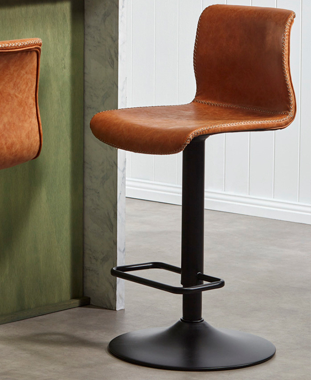 Zooming in on one stool, the focus is on the strong, black, metal pedestal base supporting the seat.