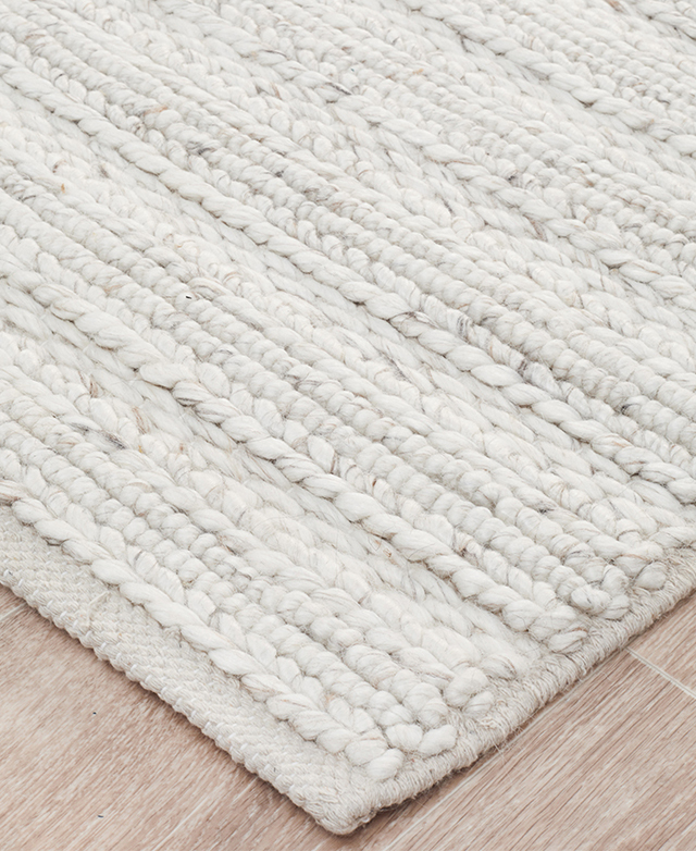 Here is a corner, close-up, of the wool-blend rug. In the frame are strongly bound edges.