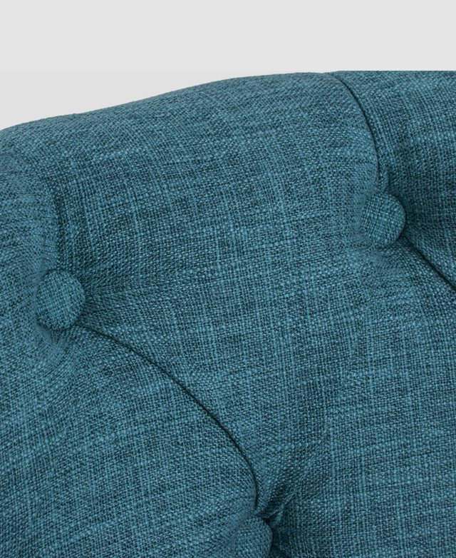 Round buttons are embedded into blue upholstery and connected by pleats. Round buttons are embedded into blue upholstery and connected by pleats.