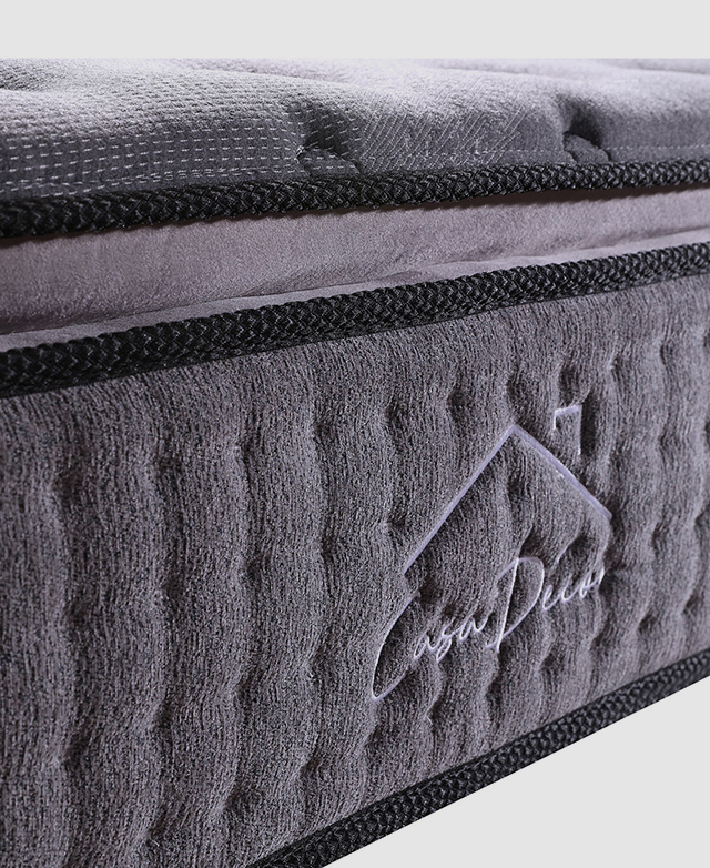 A close-up side snapshot of the grey mattress and its depth, which contains the technology to reduce partner disturbance.