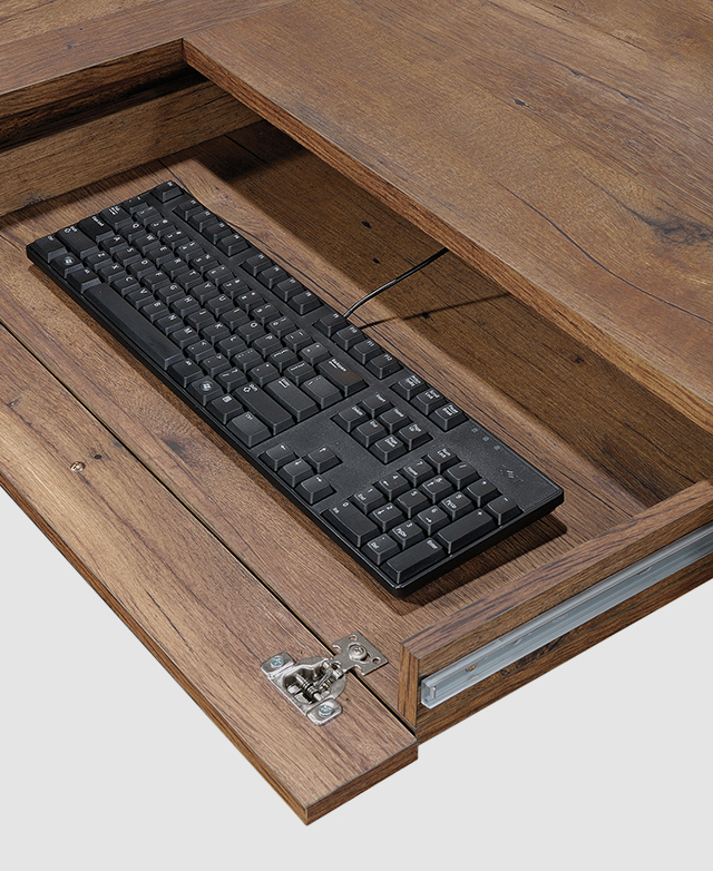 A drawer below the desk with a flip-down panel reveals practical space for a keyboard. A drawer below the desk with a flip-down panel reveals practical space for a keyboard.