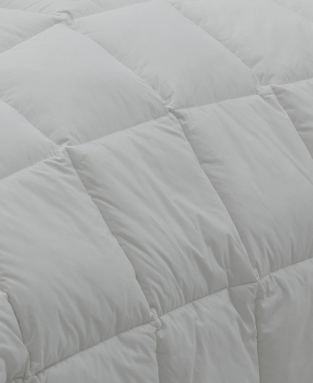 Close-up of the down and feather quilt showcases its lofty baffle-box stitch, creating a plump appearance.