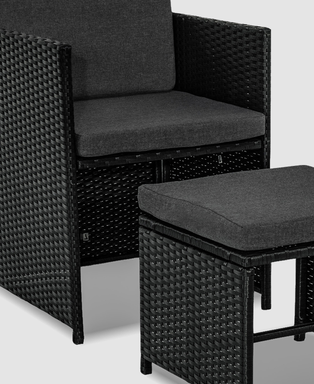 An outdoor dining chair with a wicker frame and foam-padded cushions is paired with a matching outdoor ottoman.