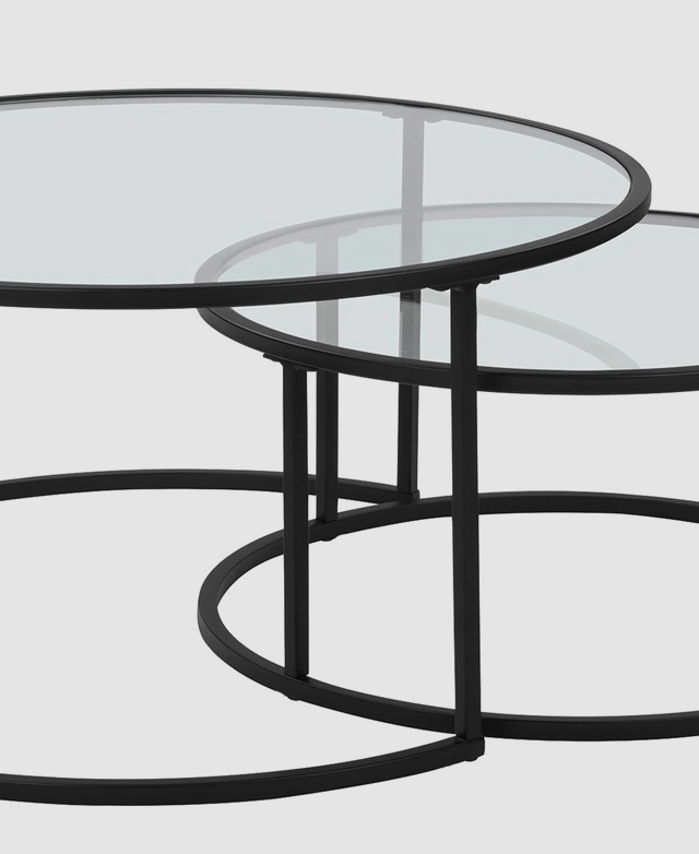The small table is partially nestled within the larger table. The small table is partially nestled within the larger table.