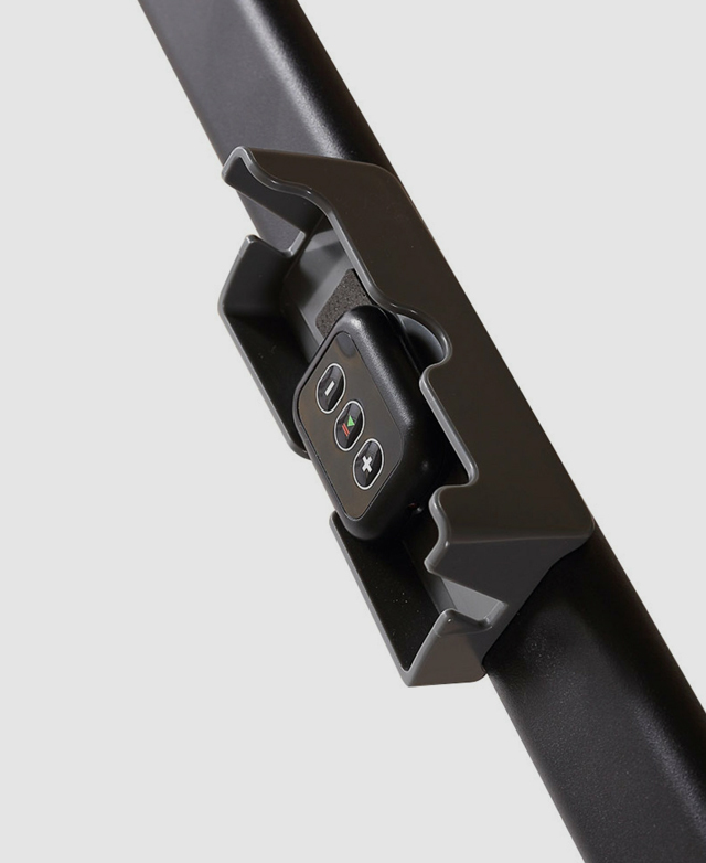 Close view of the remote control, with a plus/minus button to control the speed, and a stop/start button. Close view of the remote control, with a plus/minus button to control the speed, and a stop/start button.