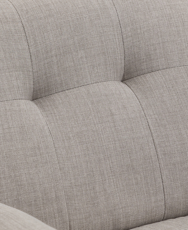 The smooth upholstery on the backrest of the chair features sewn-in tufting detail in a rectangular pattern. The smooth upholstery on the backrest of the chair features sewn-in tufting detail in a rectangular pattern.