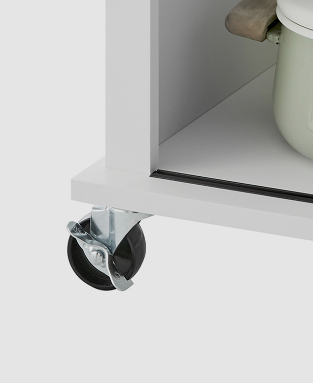 Large-scale view of one of the swivel castor wheels at the base of the island trolley. It has a brake to lock it in place.