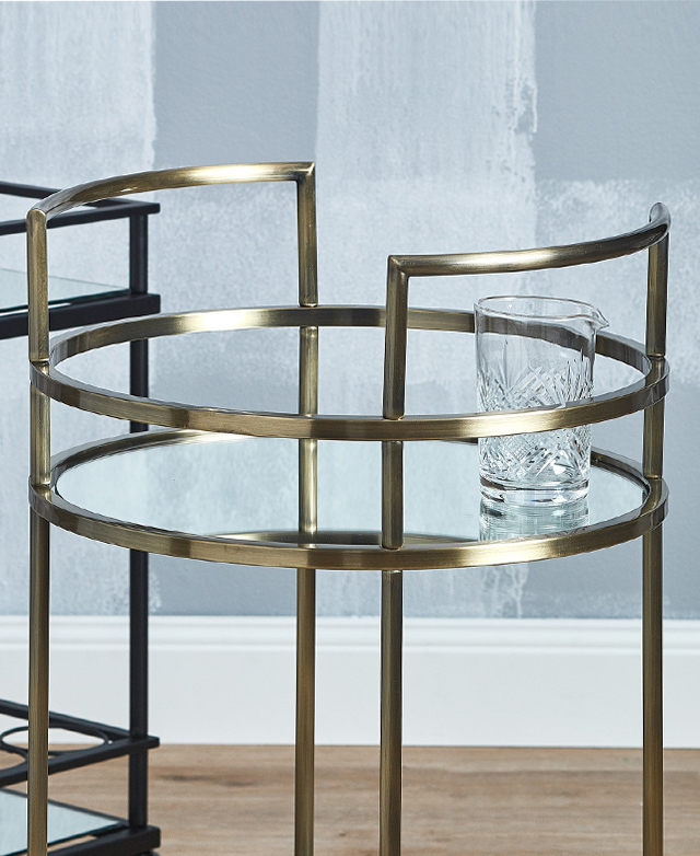 The mirrored surface of the circular glass shelves gives a reflection of the contents stored on top. The mirrored surface of the circular glass shelves gives a reflection of the contents stored on top.