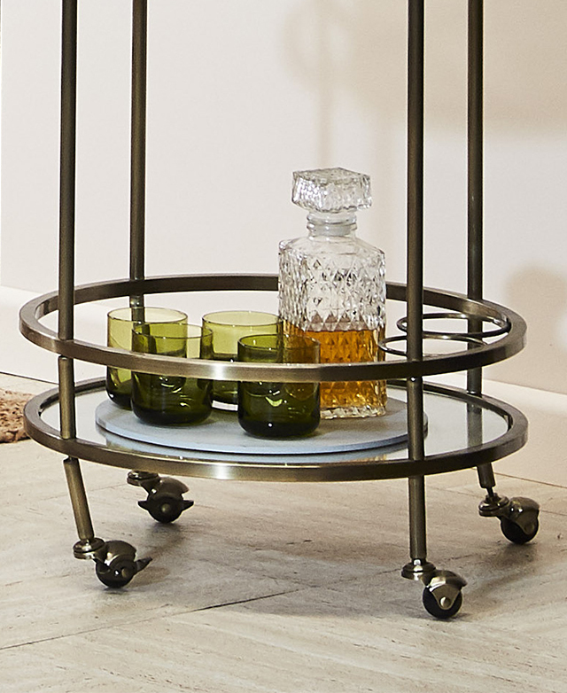 Base of the bar cart is shown, with four lockable castors sitting directly below the lower shelf. Base of the bar cart is shown, with four lockable castors sitting directly below the lower shelf.
