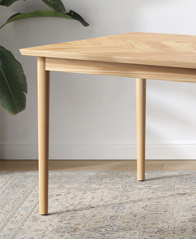 Two of the solid oak legs are the focus, their slightly tapered, slender form atop a patterned rug. Two of the solid oak legs are the focus, their slightly tapered, slender form atop a patterned rug.