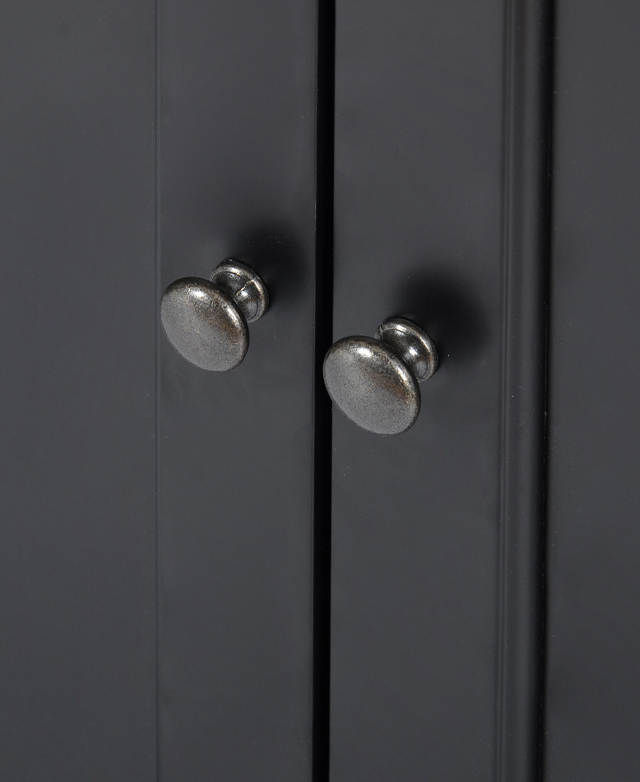 Antique-look gunmetal brass knobs are captured close-up.