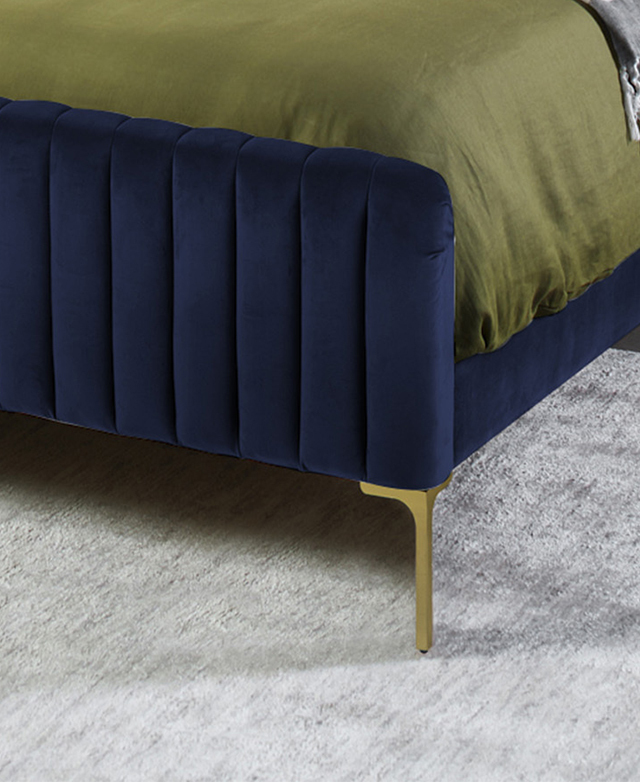 A green quilt cover on the blue bed is striking. The single golden metal leg is narrow, and it complements the bedding. A green quilt cover on the blue bed is striking. The single golden metal leg is narrow, and it complements the bedding.