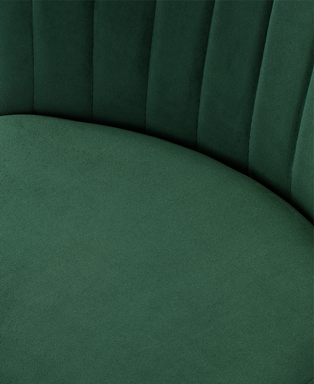 Large-scale view of green velvet upholstery on a luxury bar stool.
