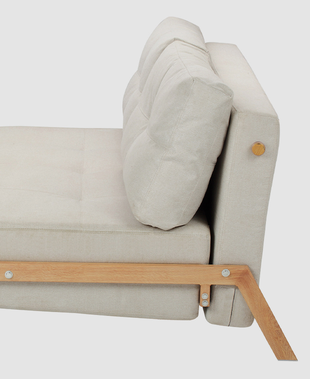 A side view of the sofa bed shows timber accents and the narrow frame that keeps the silhouette compact. A side view of the sofa bed shows timber accents and the narrow frame that keeps the silhouette compact.
